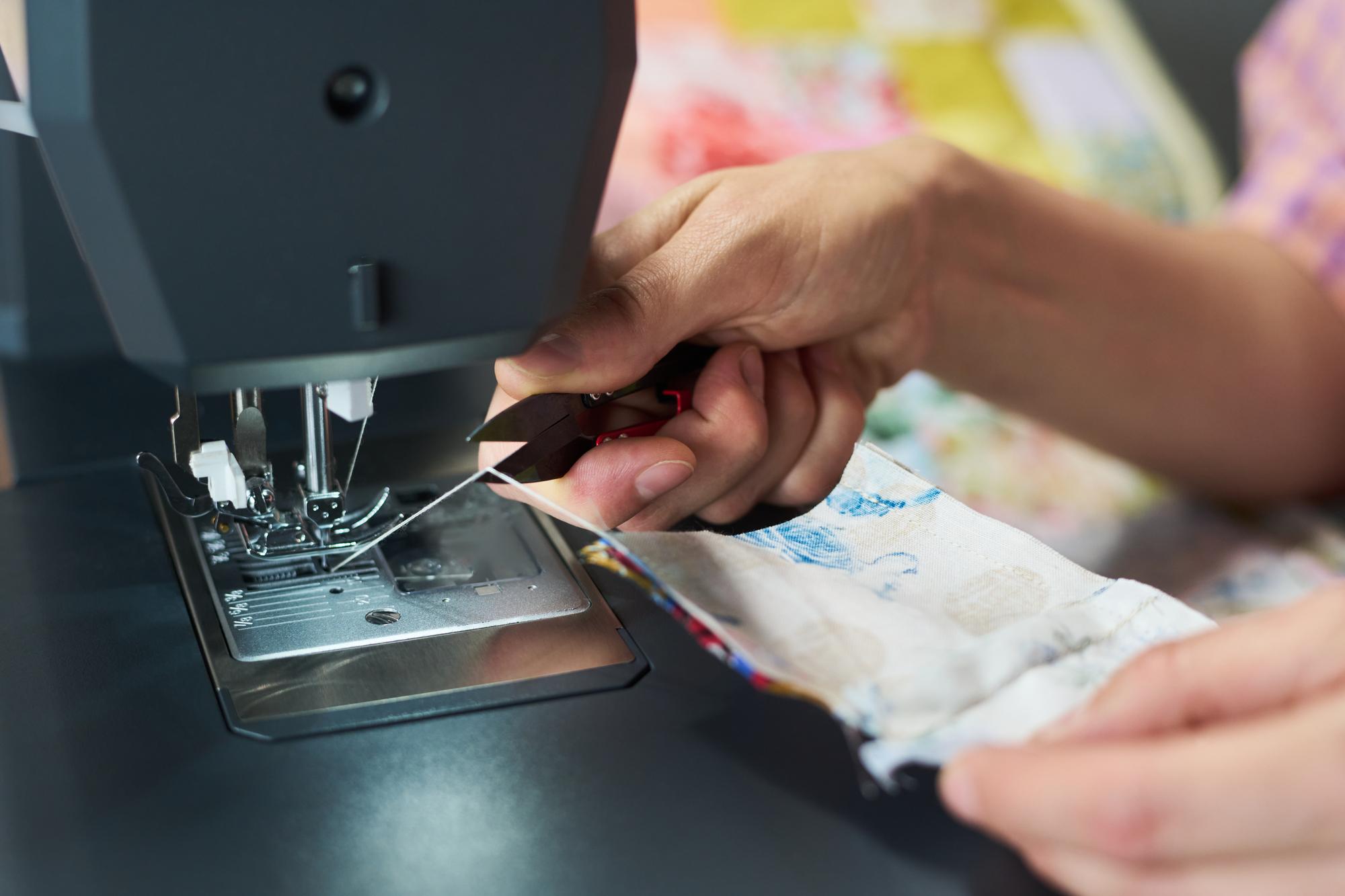Hands arranging embroidered patches on table